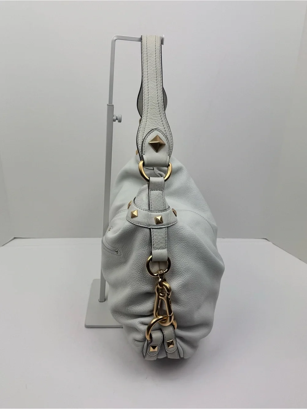 B. Makowsky Leather Ivory Hobo handbag. Gold-tone stud accent hardware.